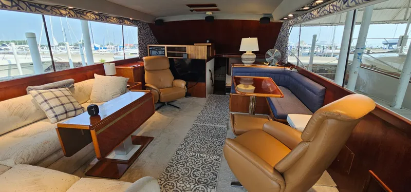 Slide: The Image of Interior of 1987 Ocean Yachts 48 Super Sport with leather chair, TV, and dining area. - 20