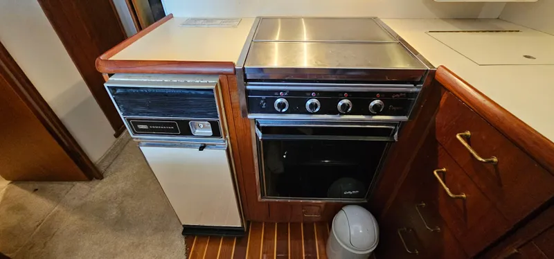 Slide: The Image of 1987 Ocean Yachts 48 Super Sport interior with vintage appliance and wooden cabinetry. - 30