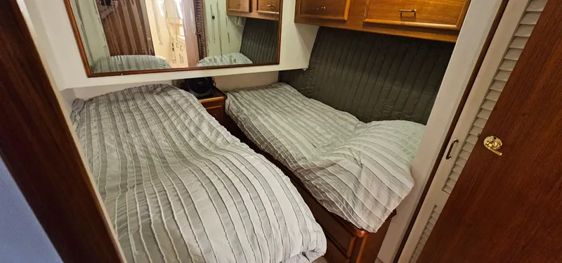 Slide: The Image of Twin beds in a cozy cabin of a 1987 Ocean Yachts 48 Super Sport. - 36