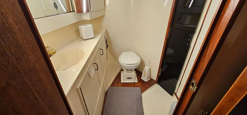 Slide: The Image of Bathroom interior of 1987 Ocean Yachts 48 Super Sport with sink, mirror, and toilet. - 38