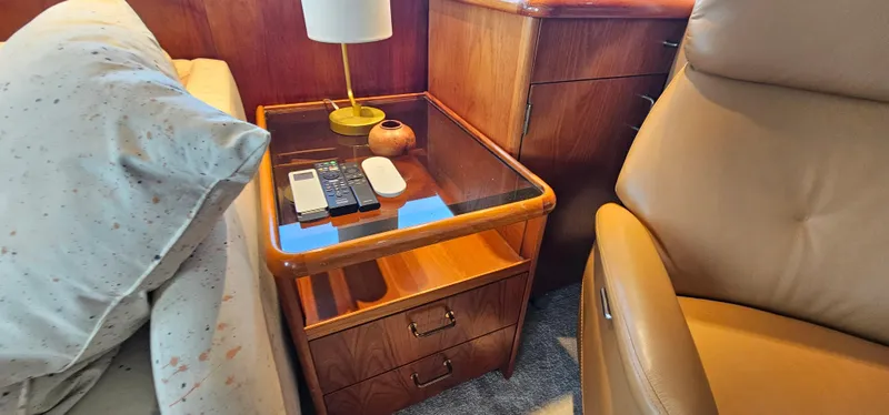 Slide: The Image of Luxurious interior of 1987 Ocean Yachts 48 Super Sport with leather chair and wooden furnishings. - 42