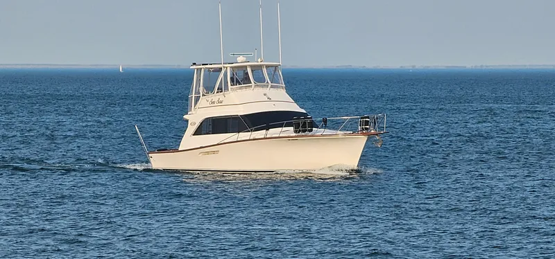 Slide: The Image of 1987 Ocean Yachts 48 Super Sport cruising on open water. - 7