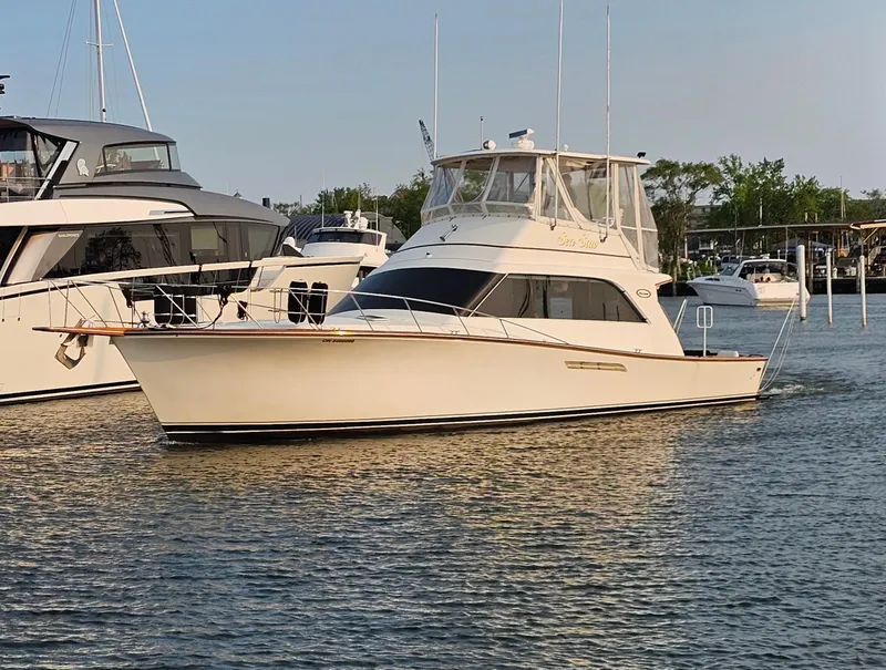 Slide: The Image of 1987 Ocean Yachts 48 Super Sport docked under a covered marina. - 8