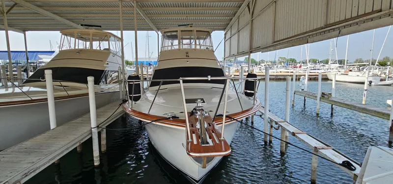 Slide: The Image of 1987 Ocean Yachts 48 Super Sport boat deck with wooden flooring and seating area. - 10