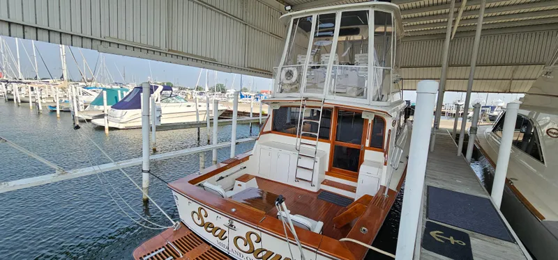 Slide: The Image of 1987 Ocean Yachts 48 Super Sport boat deck with seating at marina. - 13