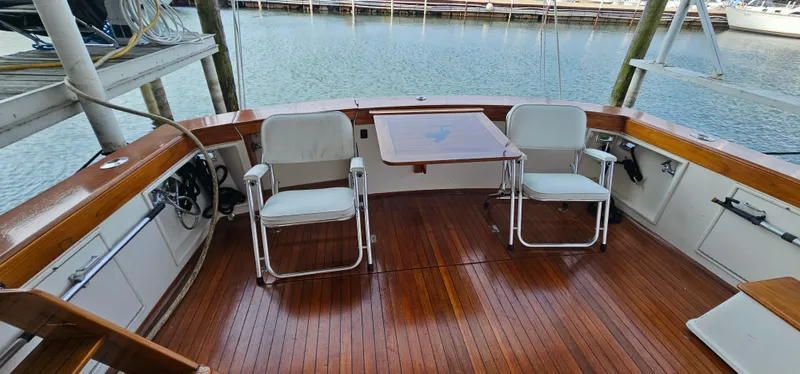 Slide: The Image of 1987 Ocean Yachts 48 Super Sport yacht interior with polished wooden table and chairs. - 15