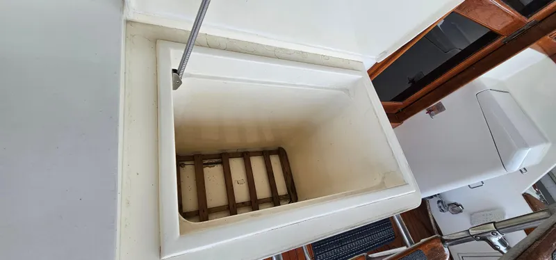 Slide: The Image of 1987 Ocean Yachts 48 Super Sport sink area with white cabinetry and faucet. - 17