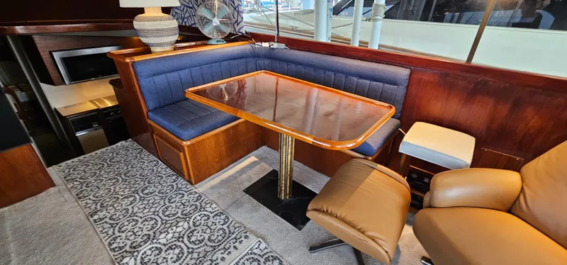 Slide: The Image of Interior of 1987 Ocean Yachts 48 Super Sport with seating, table, and recliner. - 23