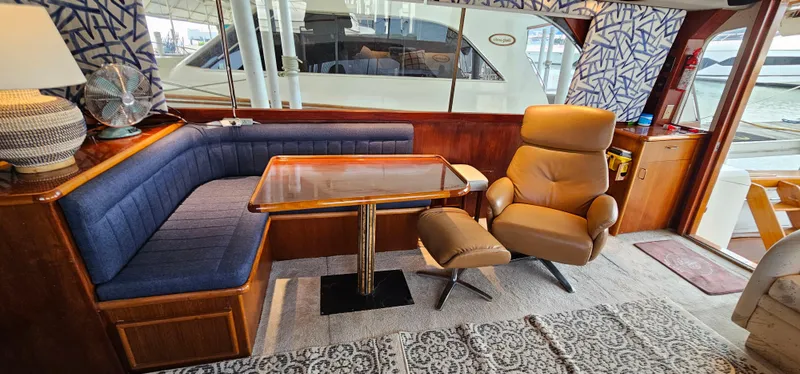 Slide: The Image of Luxurious interior of 1987 Ocean Yachts 48 Super Sport with plush seating and marina view. - 24