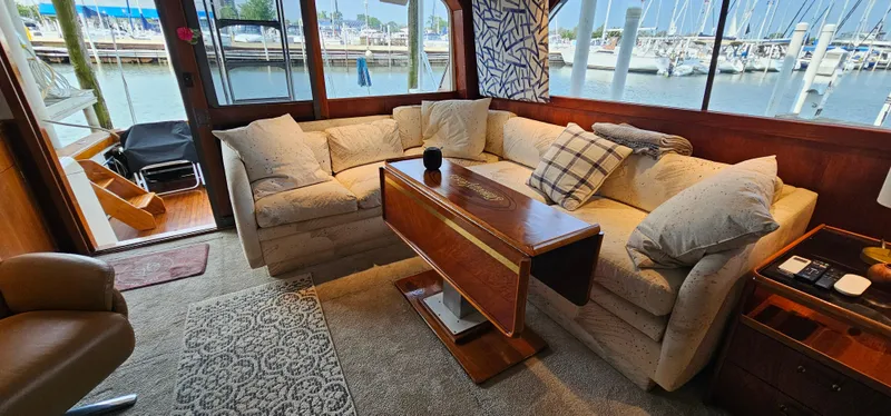 Slide: The Image of Luxurious interior of 1987 Ocean Yachts 48 Super Sport with elegant wooden table. - 25