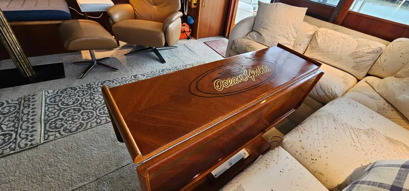 Slide: The Image of 1987 Ocean Yachts 48 Super Sport kitchen with wood cabinetry, stove, microwave, and sink. - 26