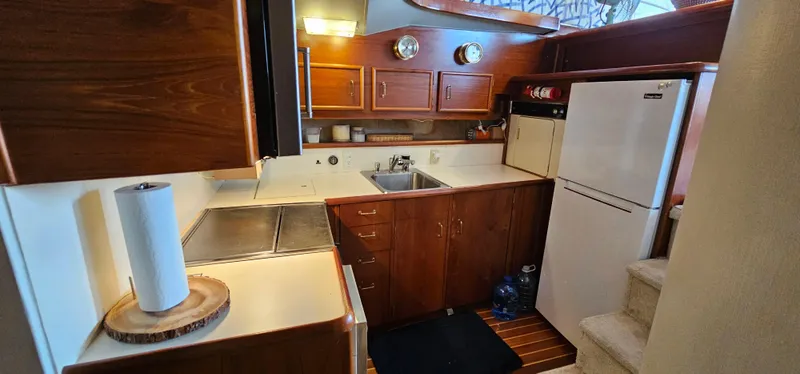 Slide: The Image of KitchenAid microwave in 1987 Ocean Yachts 48 Super Sport, stainless steel finish, wooden cabinetry. - 28