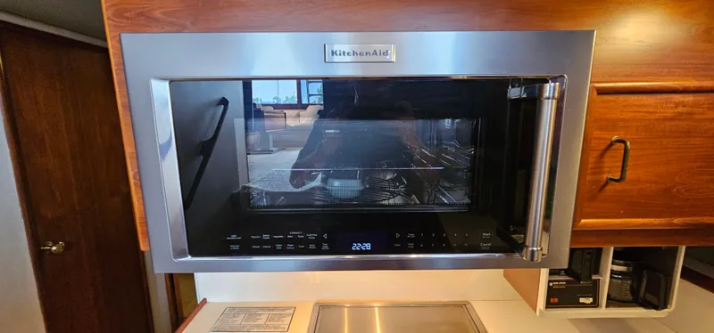 Slide: The Image of 1987 Ocean Yachts 48 Super Sport kitchen with stove, oven, and compact refrigerator. - 29
