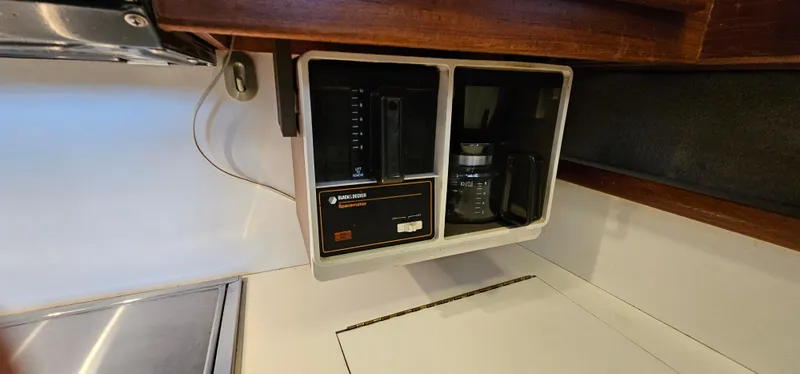 Slide: The Image of 1987 Ocean Yachts 48 Super Sport cabin with cozy bed, wooden cabinets, and nautical decor. - 32