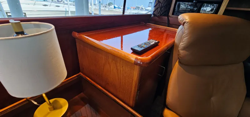 Slide: The Image of 1987 Ocean Yachts 48 Super Sport cabin interior with wooden nightstand and leather chair. - 41