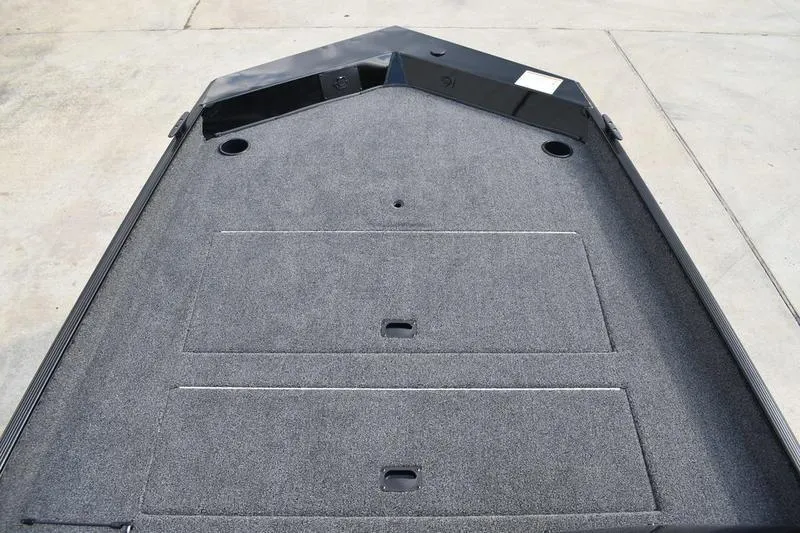 Slide: The Image of Carpeted interior detail of 2025 Lowe Skorpion 17 boat with cup holder. - 14