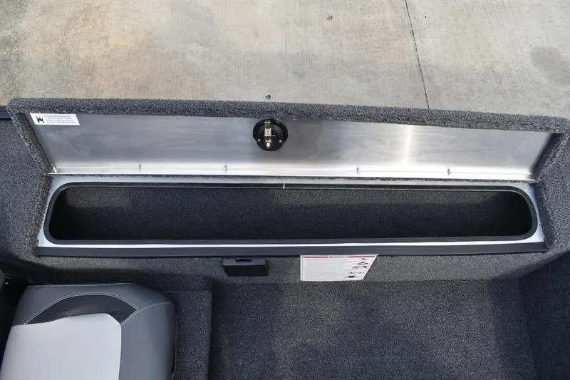 Slide: The Image of 2025 Lowe Skorpion 17 boat storage compartment with open lid, showcasing interior space. - 24