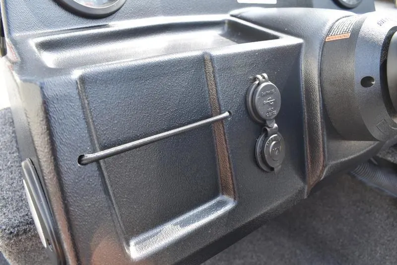 Slide: The Image of Dashboard of 2025 Lowe Skorpion 17 boat with USB ports and storage compartment. - 27