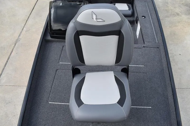 Slide: The Image of 2025 Lowe Skorpion 17 boat with Mercury engine on trailer, parked outdoors. - 6