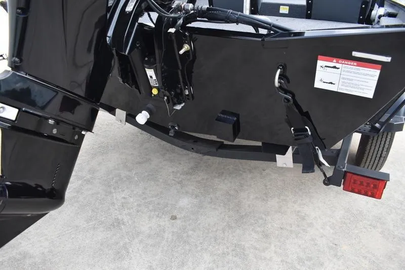 Slide: The Image of 2025 Lowe Skorpion 17 trailer wheel with black alloy rim and tire on concrete surface. - 7