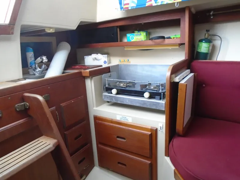 Slide: The Image of Interior of a 1988 Catalina 27 yacht featuring a kitchen area. - 5