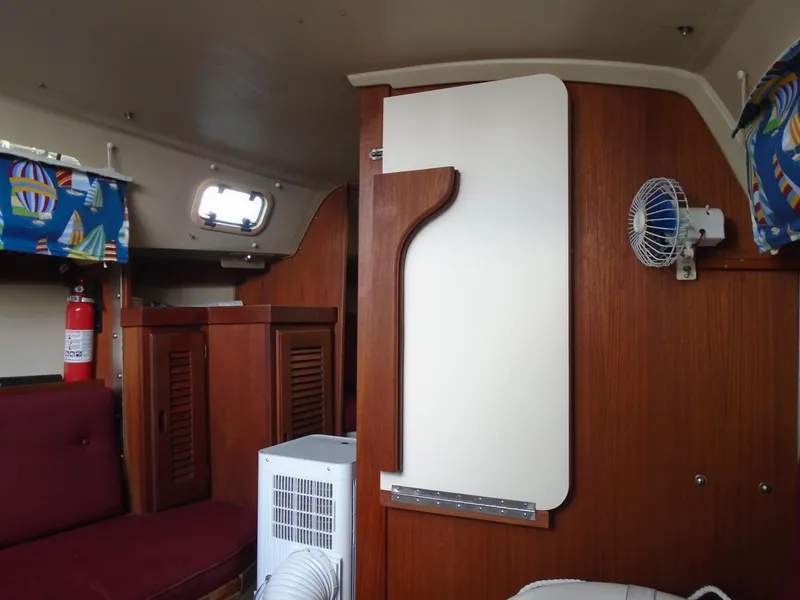 Slide: The Image of Interior of a 1988 Catalina 27 sailboat with wooden furnishings. - 6