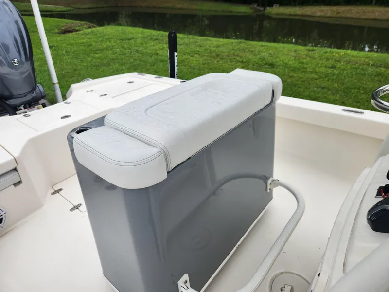 Slide: The Image of 2024 Pathfinder 2500 Hybrid boat seat with storage, near a serene waterway. - 16