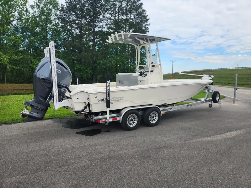 Slide: The Image of 2024 Pathfinder 2500 Hybrid boat on trailer, parked outdoors, with trees in the background. - 3