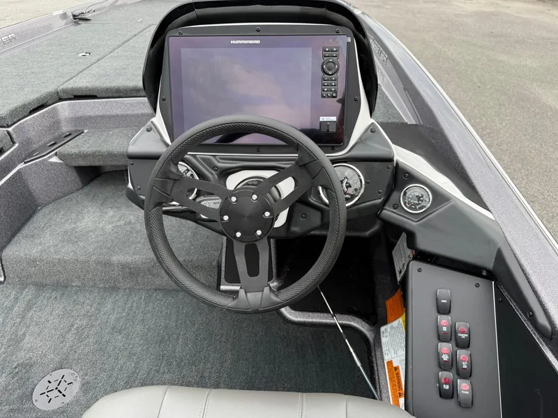 Slide: The Image of 2025 Skeeter ZXR 21 SE boat dashboard with steering wheel and electronic display. - 10