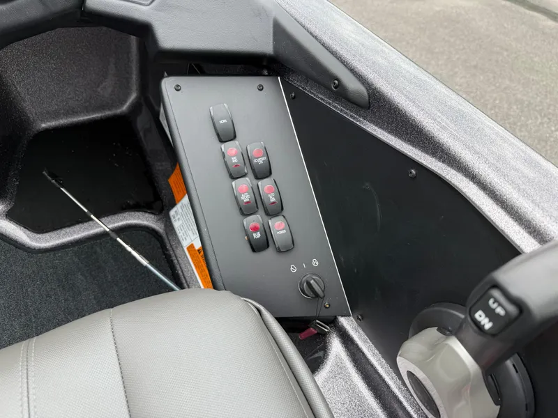 Slide: The Image of Control panel of 2025 Skeeter ZXR 21 SE boat with switches and steering wheel. - 13