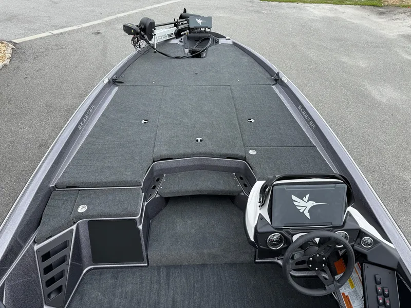 Slide: The Image of 2025 Skeeter ZXR 21 SE boat interior with steering wheel and spacious deck. - 15