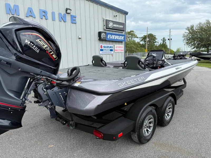 Slide: The Image of 2025 Skeeter ZXR 21 SE boat with Yamaha engine, parked outside a marine dealership. - 18