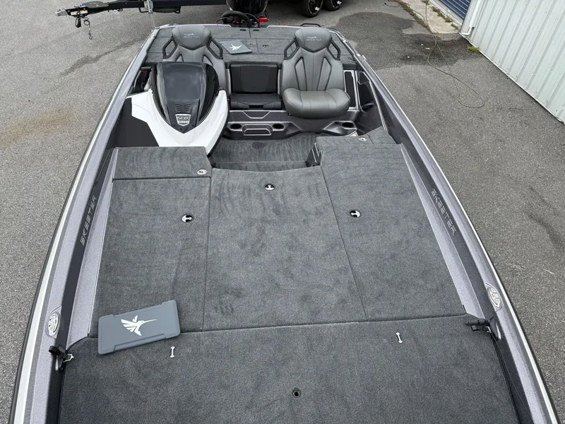 Slide: The Image of 2025 Skeeter ZXR 21 SE boat interior with gray seating and carpeted deck. - 7