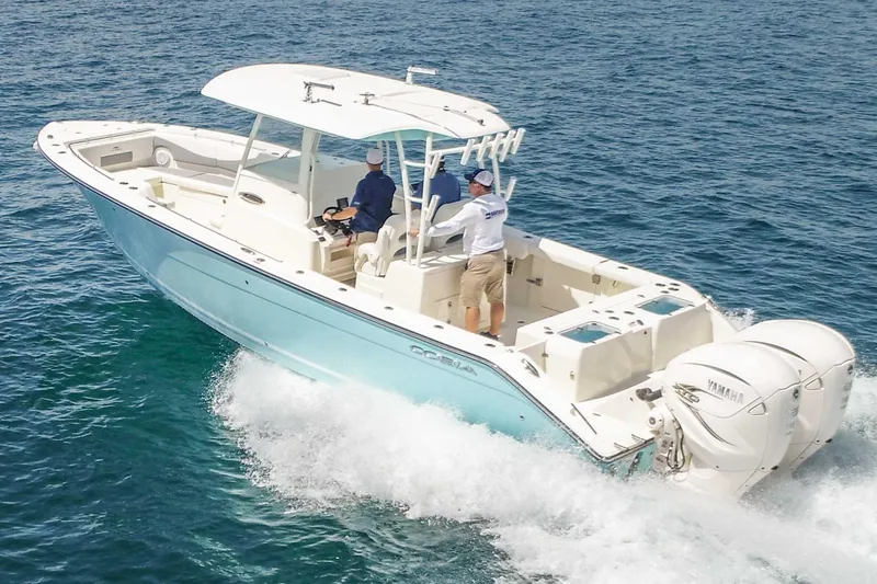 Slide: The Image of 2020 Cobia 320 Center Console boat cruising on open water. - 0