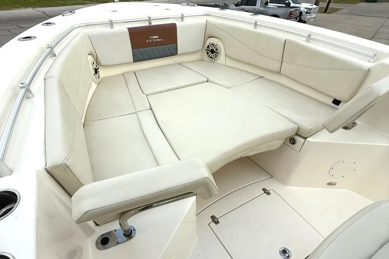 Slide: The Image of 2020 Cobia 320 Center Console boat with spacious white seating area. - 10