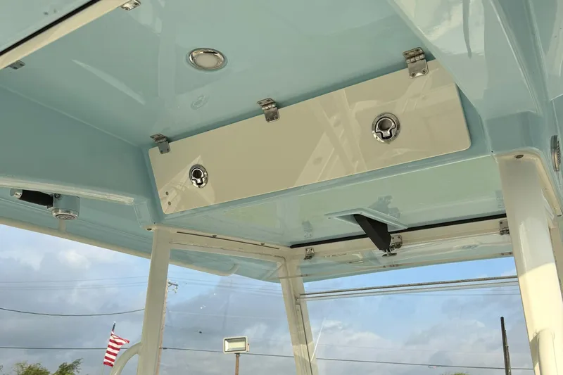 Slide: The Image of 2020 Cobia 320 Center Console boat interior ceiling with storage compartments and lighting. - 12