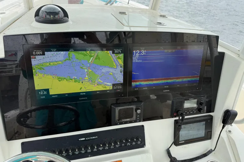 Slide: The Image of 2020 Cobia 320 Center Console dashboard with navigation and sonar displays. - 15