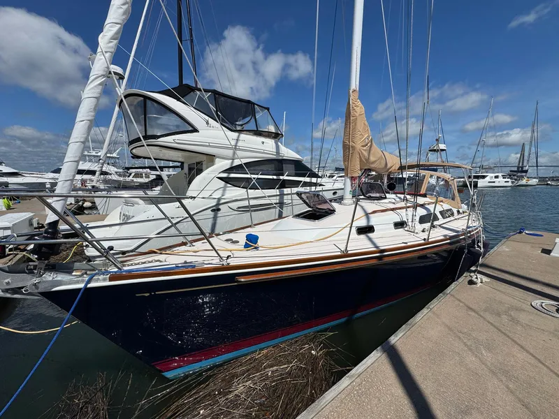 Slide: The Image of Sailboat Sabre 362, 2000 model, docked at marina under clear blue sky. - 0