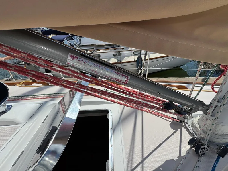 Slide: The Image of Sailboat rigging on a 2000 Sabre 362, featuring red ropes and a metal boom. - 14