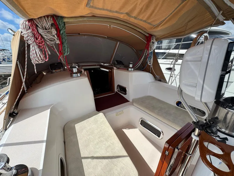 Slide: The Image of Cockpit of 2000 Sabre 362 sailboat with beige canopy and neatly coiled ropes. - 23