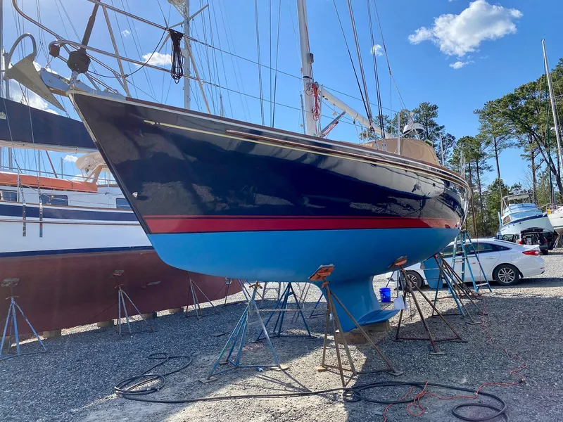 Slide: The Image of Sailboat on stands, Sabre 362 model, 2000, in a boatyard under clear blue sky. - 28