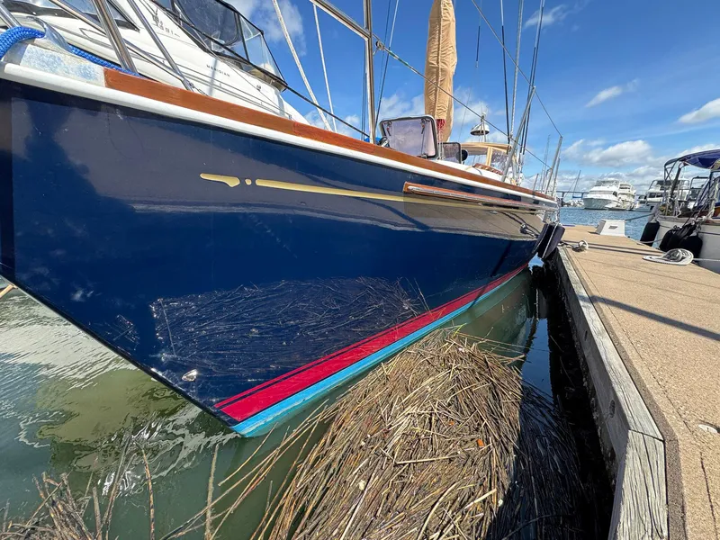 Slide: The Image of Blue Sabre 362 sailboat docked, 2000 model, with clear sky and marina background. - 3