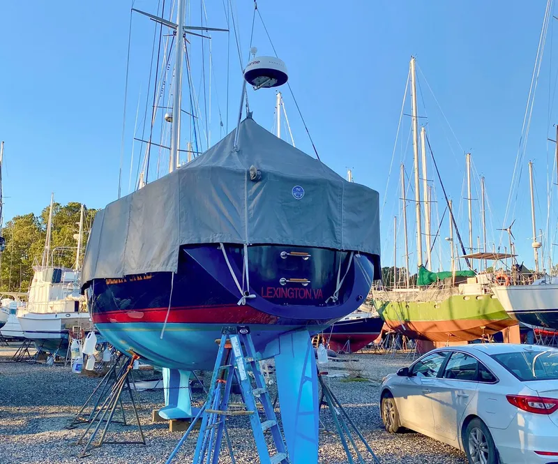Slide: The Image of Sailboat Sabre 362, 2000 model, covered and docked in a boatyard with other vessels. - 30