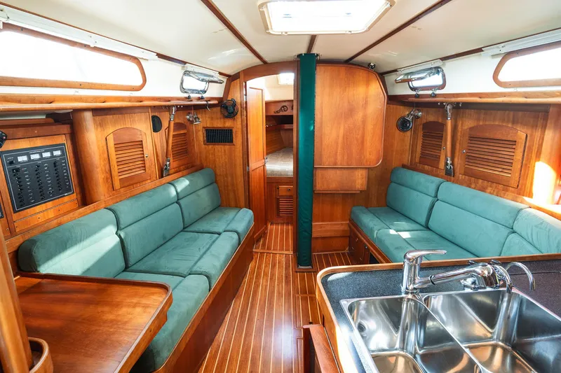 Slide: The Image of Interior of a 2000 Sabre 362 sailboat with wooden finish and green seating. - 33