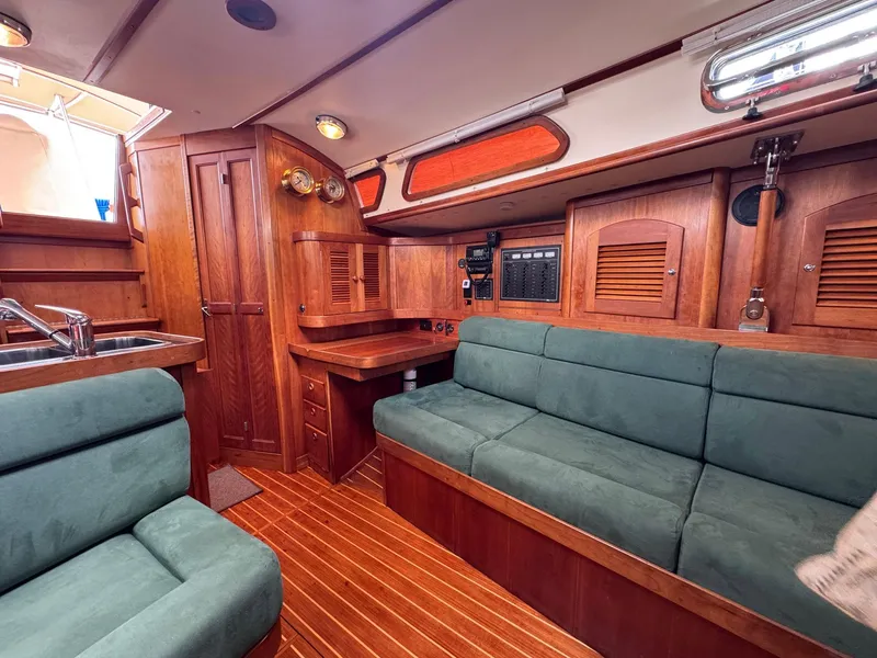 Slide: The Image of Interior of 2000 Sabre 362 sailboat with wood finish and green upholstery. - 35