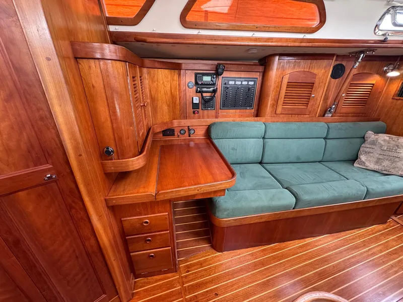 Slide: The Image of Interior of 2000 Sabre 362 yacht with wooden cabinetry and green cushioned seating. - 38