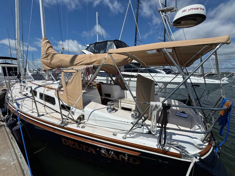 Slide: The Image of 2000 Sabre 362 sailboat docked, featuring tan canvas covers and Raymarine equipment. - 4
