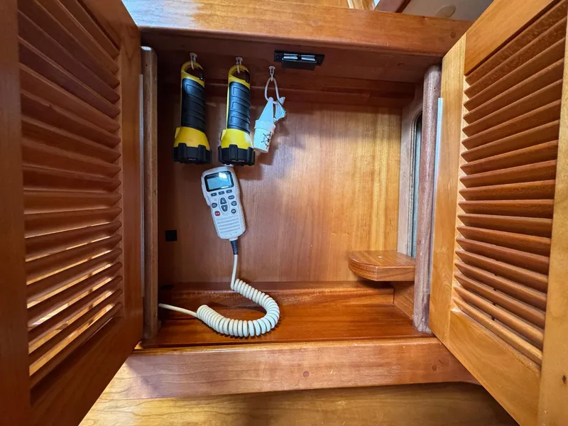 Slide: The Image of Wooden cabinet with radio and flashlights inside a 2000 Sabre 362 sailboat. - 42