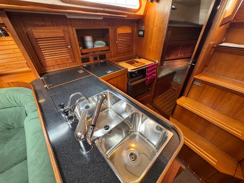 Slide: The Image of Interior of 2000 Sabre 362 yacht showing kitchen sink and wooden cabinetry. - 45