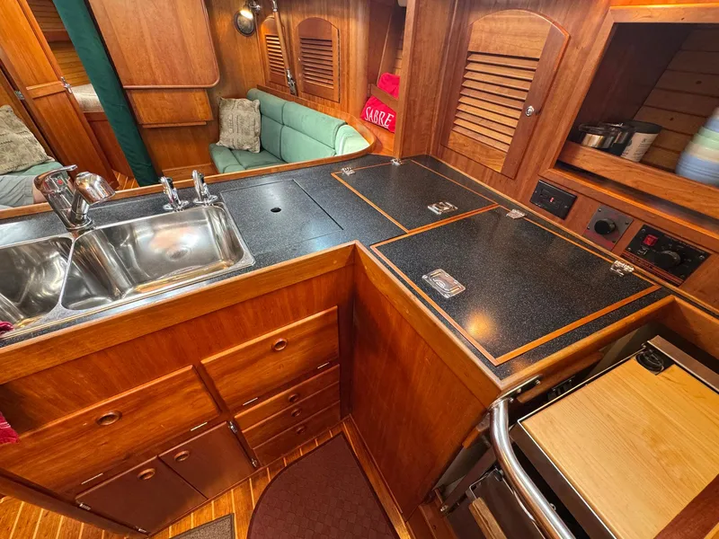Slide: The Image of Interior of 2000 Sabre 362 sailboat galley with wood cabinetry and dual sink. - 46